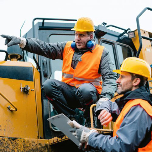 Supervisor checking with machine operator what job he is doing